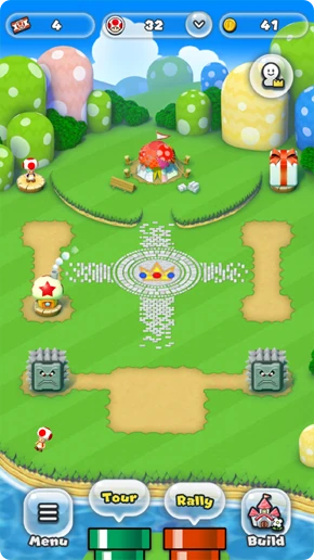 مملكة Super Mario Run مع مبانٍ وزينة وعوائق حجرية وزر Build في الأسفل