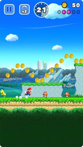 ماريو قرب أعداء Goomba وخط عملات، وزر الفقاعة ×2 بجوار الإيقاف المؤقت